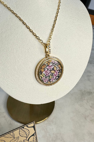 A fantastic Aurora pendant. The finest painting of soft pink orchids surrounded by butterflies on a noble dark grey background represents luxury, splendour and exclusivity. VARVARA collection. 74 sparkling diamonds, 18K yellow gold.